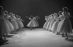 a black and white photo of dancers in tutu skirts