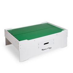 a white box with green lid and drawers on the bottom, sitting against a white background