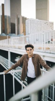 a man standing on top of a metal railing