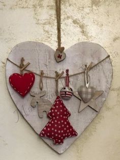 a heart shaped hanging decoration with clothes pins