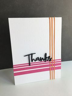 a thank card with the word thanks written in black ink on white paper and pink stripes