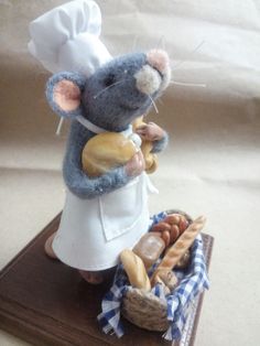 a figurine of a mouse holding bread