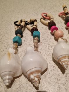 four seashells are lined up on the counter