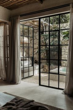 an open door leading to a bedroom with a jacuzzi tub in the corner