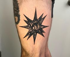 a man's leg with a star tattoo on it