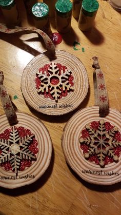 three christmas ornaments are sitting on a table