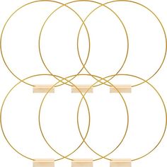 four gold circles with wooden bases on a white background