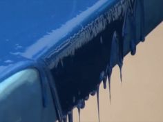 icicles on the hood of a blue car