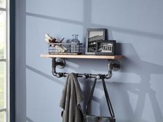 a shelf that has some items on it and is next to a window with blue walls