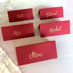 red place cards with gold lettering on them