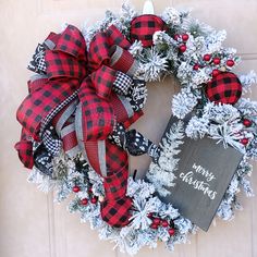 a christmas wreath with a chalkboard attached to it