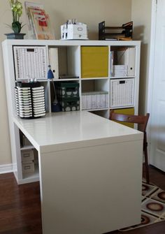 a white desk with lots of baskets on it