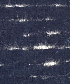 an image of the back side of a piece of cloth with white thread on it