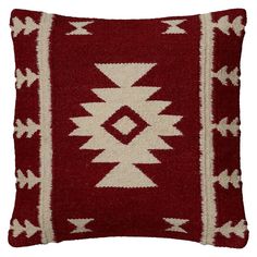 a red and white pillow with an arrow design on the front, sitting on a white background