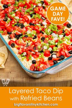 layered taco dip with refried beans and game day fave