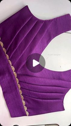 the back of a purple dress with gold trim