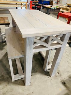 a table made out of wood sitting in a shop