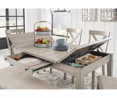 a dining room table with an open drawer in the center and plates on the other side