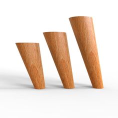 three wooden cones are lined up against each other