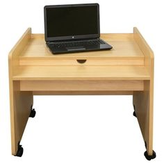 a laptop computer sitting on top of a small wooden desk with wheels and casters