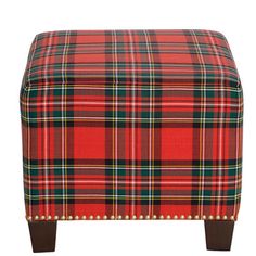 a red and green plaid ottoman with wooden legs