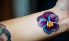 a purple flower with yellow center on the left side of the arm and right hand