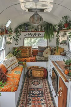 the inside of an rv with plants and rugs