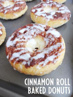 cinnamon roll baked donuts on a baking sheet