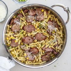 a pan filled with pasta and meat on top of a table