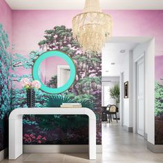 a room with a mirror, table and wall mural