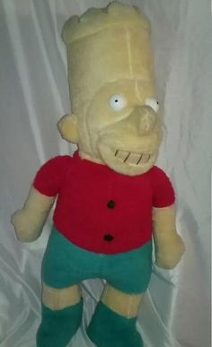 a stuffed toy with a red shirt and green pants