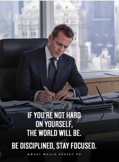 a man sitting at a desk in front of a window with a quote on it that says, if you're not hard