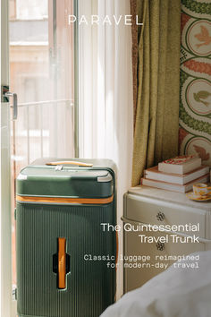 a suitcase sitting next to a window in a room