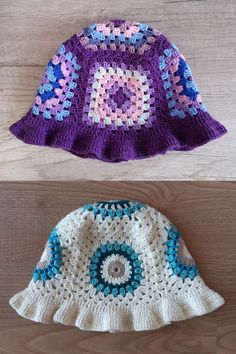 two crocheted hats sitting next to each other on top of a wooden table