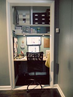 an office area with a desk, chair and shelves in the corner on either side