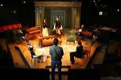 a group of people sitting on top of a stage