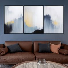 a living room with two paintings on the wall