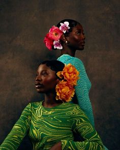 two black women with flowers in their hair