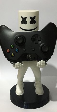 a close up of a toy with a controller in it's hands on a white surface