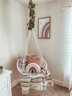 a baby's swing in the corner of a room