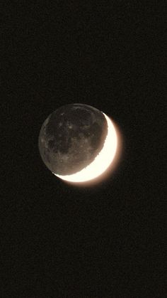 the moon is visible in the dark sky