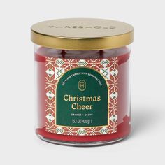 a jar of christmas cheer with a gold lid on a white background and a green label in the middle