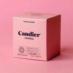 a pink candy box sitting on top of a pink surface