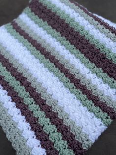 a crocheted blanket sitting on top of a table