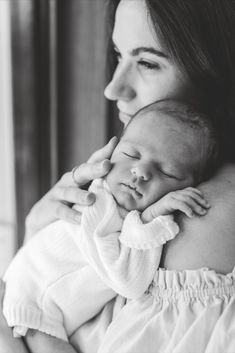 a woman holding a baby in her arms