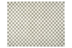 a checkered rug with white and grey squares