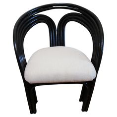 a black and white chair with a cushion on top of it's back end