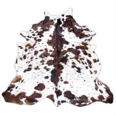 a cowhide rug with brown and white spots