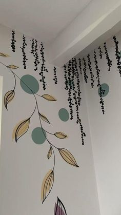 the wall is decorated with black beads and green leaves hanging from it's ceiling