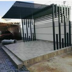 an outdoor patio with black and white striped pergolated coverings on the sides